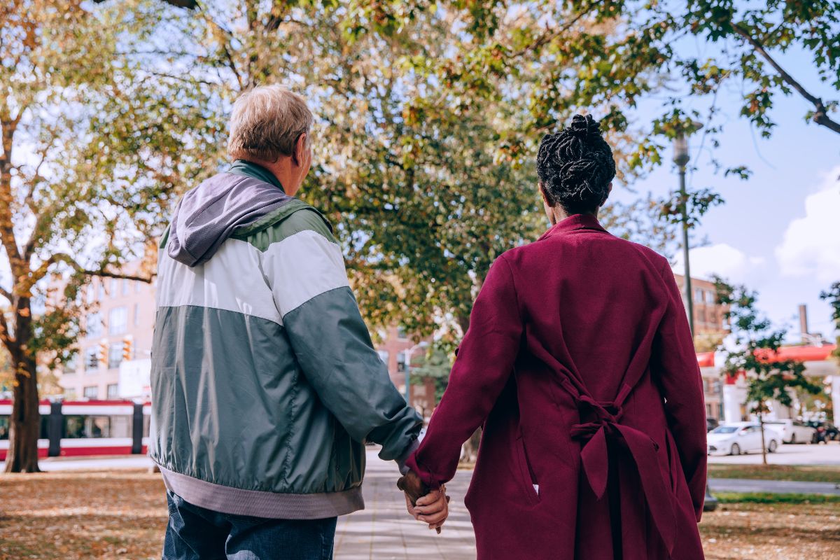 older people holding hands